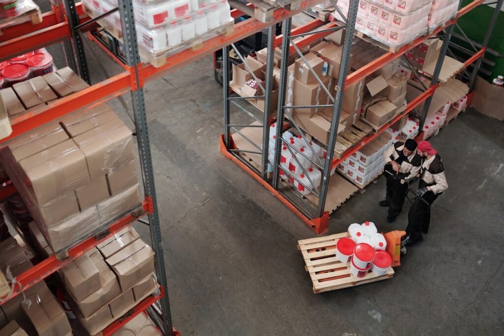 The Art of Drawing Readers In: Your attractive post title goes here Workers managing inventory on shelves in a warehouse, viewed from above.