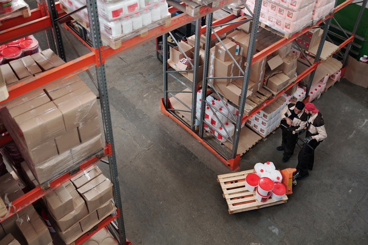 The Art of Drawing Readers In: Your attractive post title goes here Workers managing inventory on shelves in a warehouse, viewed from above.